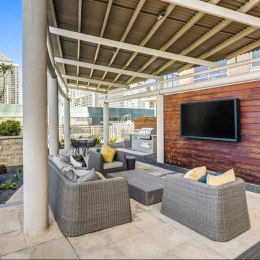 State-of-the-art amenities outdoor media area with a tv