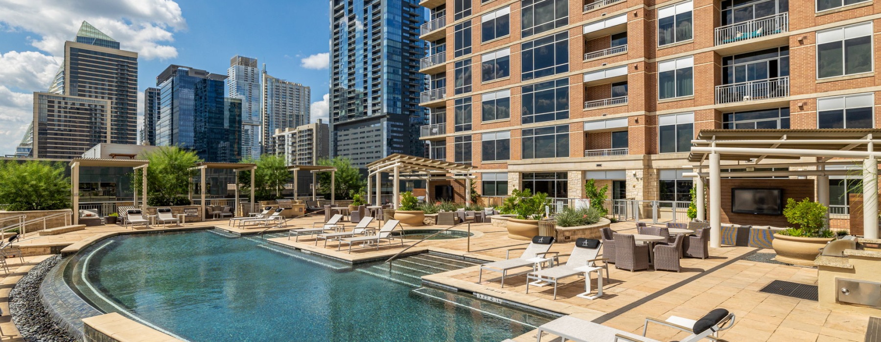 Resort-style swimming pool with sundeck at Ashton Austin apartments for rent in Austin